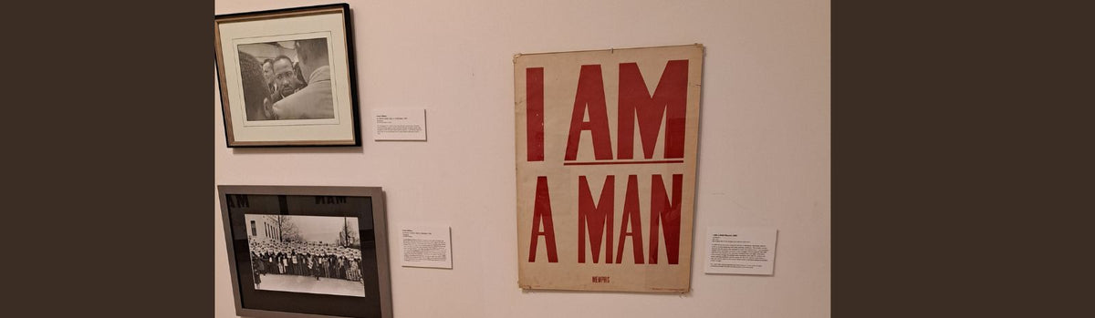 A wall featuring three historical images, two photos of Martin Luther King Jr. and union workers, and an I AM A MAN sign.
