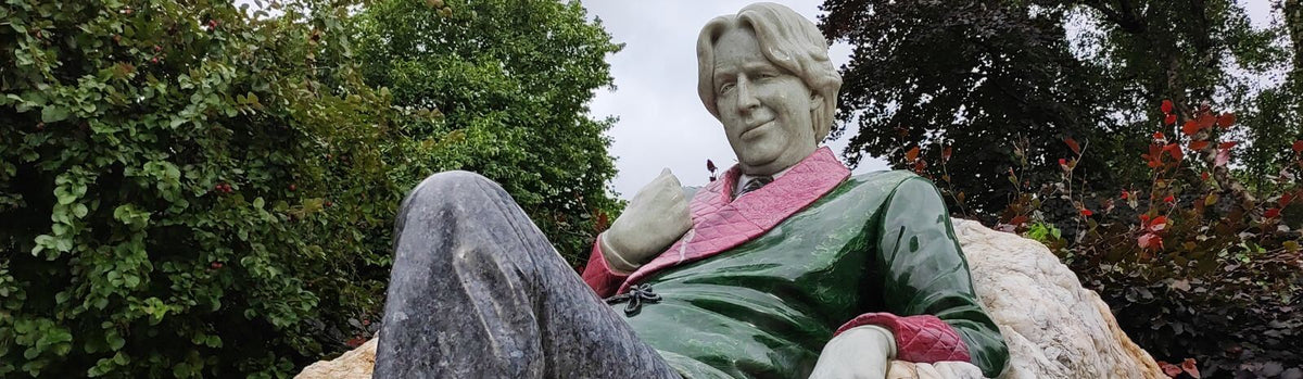 The Oscar Wilde statue in Dublin, Ireland: a statue of a man lounging on a rock.