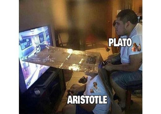 Plato and Aristotle split screen meme: cardboard divides a TV, Plato sits high watching the top half, Aristotle sits on the floor watching the bottom half