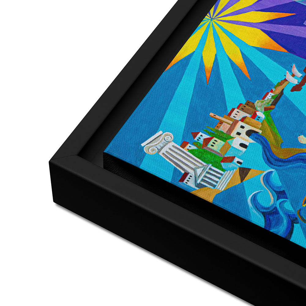 A close-up angled view of a framed colorful artwork on a white background. The piece features a bold abstract design with blue rays, yellow and purple starburst shapes, and a stylized cityscape with white buildings and green hills, all enclosed in a thick black frame.